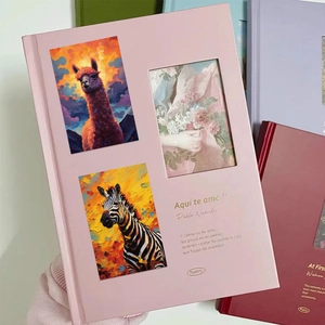 Pink poetry journal with animal stickers and floral art window held in hands