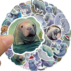 Close-up showing various manatee stickers with festive designs on a clean background