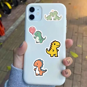Close-up of cute cartoon dinosaur waterproof stickers applied on a white smartphone case