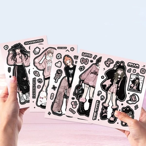 Close-up of DIY cartoon girl stickers in pink and black for journals and cases