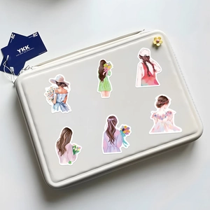 Detail of six watercolor girl back stickers displayed on a white laptop bag surface