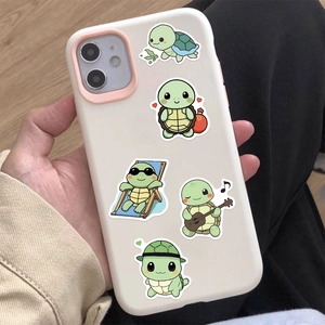 Close-up of cute cartoon turtle stickers on a white silicone phone case handheld view