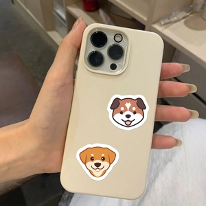 Handheld shot of beige iPhone case featuring cute cartoon dog illustrations