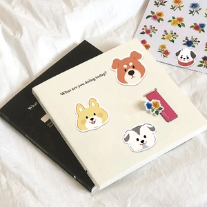 Creative cartoon puppy and floral stickers on a minimalist notebook cover for DIY decoration