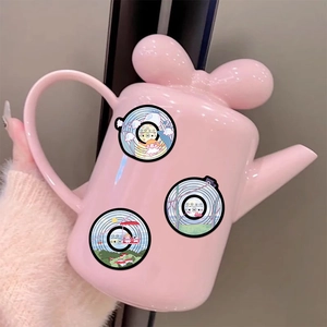 Detail of pink teapot with bow lid and original cartoon aesthetic vinyl stickers