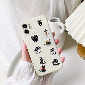 Close-up of DIY black cat stickers applied to a white phone case with cute space themes
