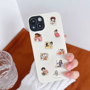 Detail of white iPhone case featuring cartoon life stickers and metal lens protection