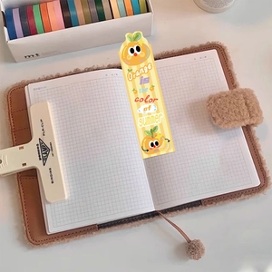 Close-up of cute cartoon orange paper bookmark with summer quote on striped background
