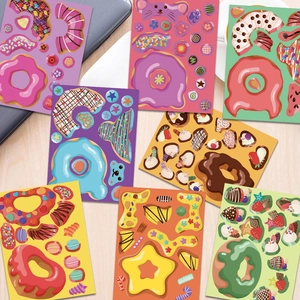 Detailed view of 8 colorful cartoon donut stickers spread on a wooden desk with a laptop