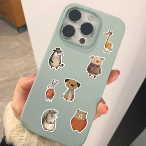 Close-up of hand-drawn animal stickers on light green iPhone case with warm sweater sleeve