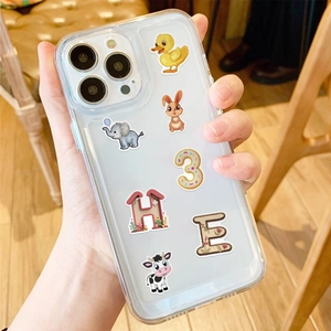 Close-up of a clear phone case decorated with cute animal stickers and colorful letters