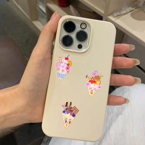 Close-up of cream iPhone case featuring cute cartoon ice cream cone prints in hand