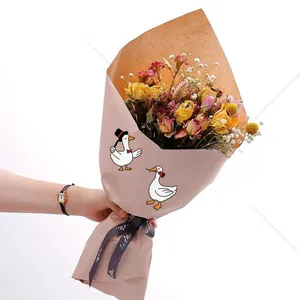Close-up of dried flower bouquet with yellow roses and cute cartoon white goose stickers