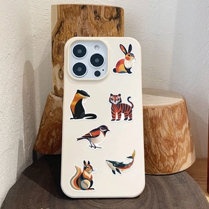 Close-up of matte iPhone case with cute cartoon animal illustrations on a wooden stand