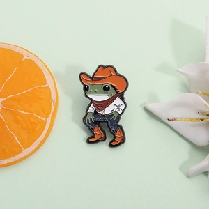 Funny cowboy frog enamel pin badge featuring a western hat and red scarf accessories