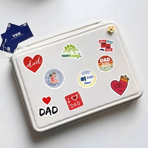 Detail of waterproof Father's Day stickers with cartoon designs on a laptop bag