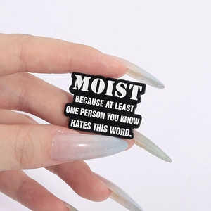 Funny black enamel pin with white text quote Moist because at least one person hates this word