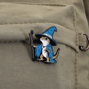 Detailed wizard lizard enamel pin attached to a green nylon backpack for decoration