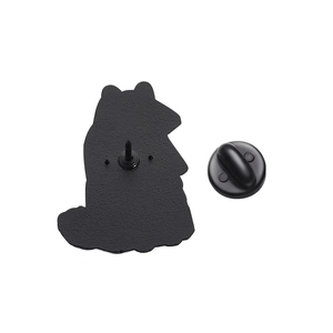 Detail view of the metal raccoon brooch back with a secure black rubber clutch fastener