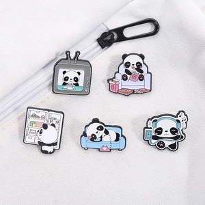 Set of five cute cartoon panda enamel pins on a white canvas bag showing various panda scenes