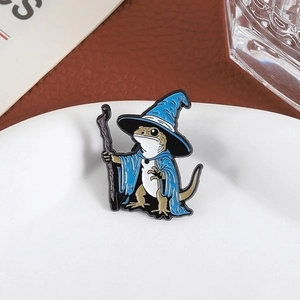 Detail view of wizard lizard enamel pin on a white ceramic plate and leather background