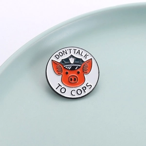 Detailed view of enamel pig sheriff badge featuring Don't Talk to Cops text on a plate