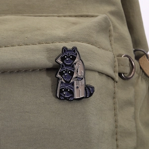 Funny enamel raccoon brooch made of zinc alloy on a green canvas bag pocket