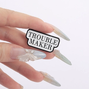Enamel brooch with Trouble Maker quote in black and white for backpack and clothing accessories