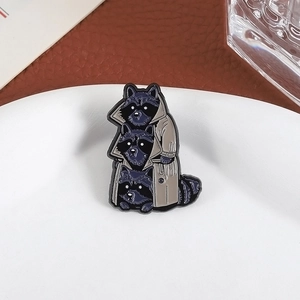Detailed close-up of three cute raccoons wearing trench coats enamel lapel pin accessory