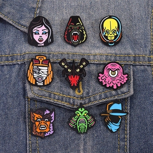 Set of 9 horror movie character enamel pins pinned on a blue denim jacket pocket
