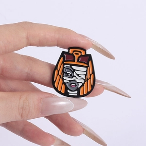 Detail of a gothic monster enamel pin featuring a bandaged face with vibrant colors
