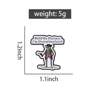 Detail view of a cowboy frog enamel pin with size specs and text Hold On Partner