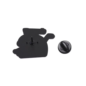 Detail view of cartoon enamel pin back featuring black lacquer finish and rubber clutches