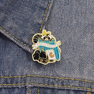 Cartoon trash panda enamel pin featuring a raccoon in a blue bin on denim fabric