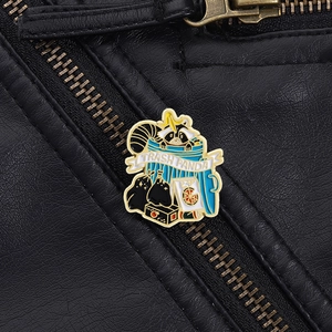 Detail of creative Trash Panda enamel pin on a black leather jacket with vibrant colors