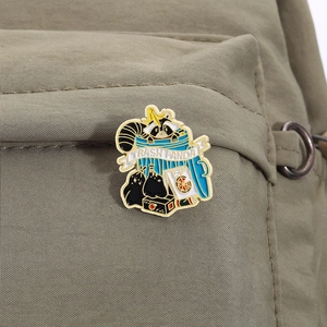 Cartoon trash panda raccoon enamel pin attached to a green canvas backpack pocket