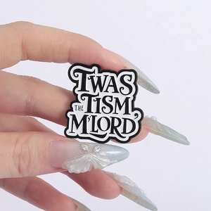 Close-up of Twas The Tism M'Lord enamel pin badge with artistic black and white design