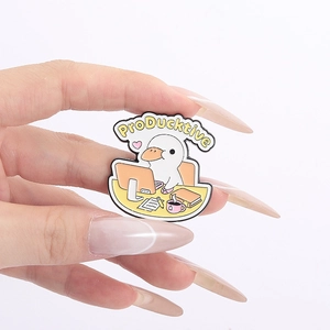 Cute white duck enamel pin working at a computer with ProDucktive text for bags