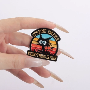 Macro detail of the enamel brooch featuring a cat and I'm Fine slogan on a shirt