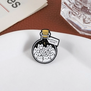 Happiness Potion black cat enamel pin brooch featuring a glass bottle design on white plate