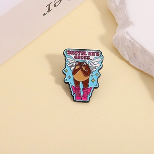 Detailed view of enamel frog pin with Bestie He's Gross text and pink boots