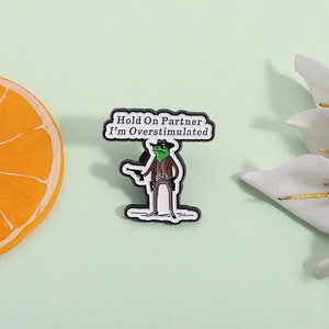 Enamel pin of a green cowboy frog with quote Hold On Partner I'm Overstimulated