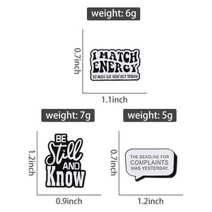 Detailed view of three black and white enamel badges featuring witty English quotes