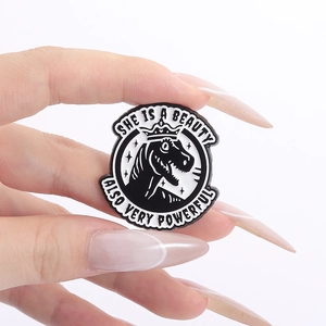 Retro dinosaur enamel pin badge featuring a crowned T-Rex and inspirational power quote