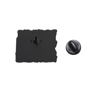 Macro shot of metal enamel pin back with durable black rubber clutch on white background