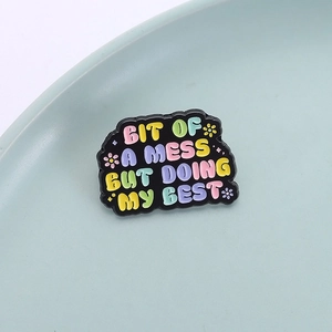 Cartoon enamel pin with 'Bit of a mess but doing my best' quote and colorful floral art