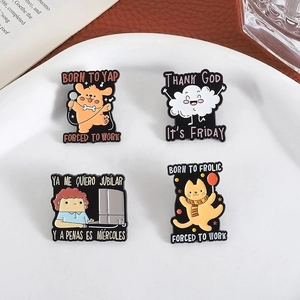Detail of four cartoon enamel pins featuring puppy and cat designs on a white plate