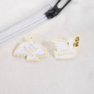 Detail view of peace dove enamel pins with slogans on a white canvas backpack