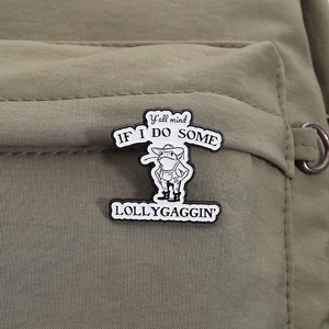Funny cartoon frog cowboy enamel pin badge with quote on a green nylon backpack strap