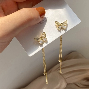 Detail of gold butterfly tassel earrings with pavé crystals and S925 silver posts
